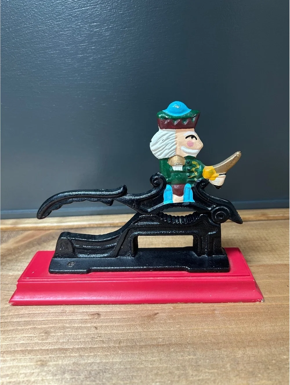 Vintage Cast Iron Nutcracker with Colorful King Figure on Red Base 7x5in.